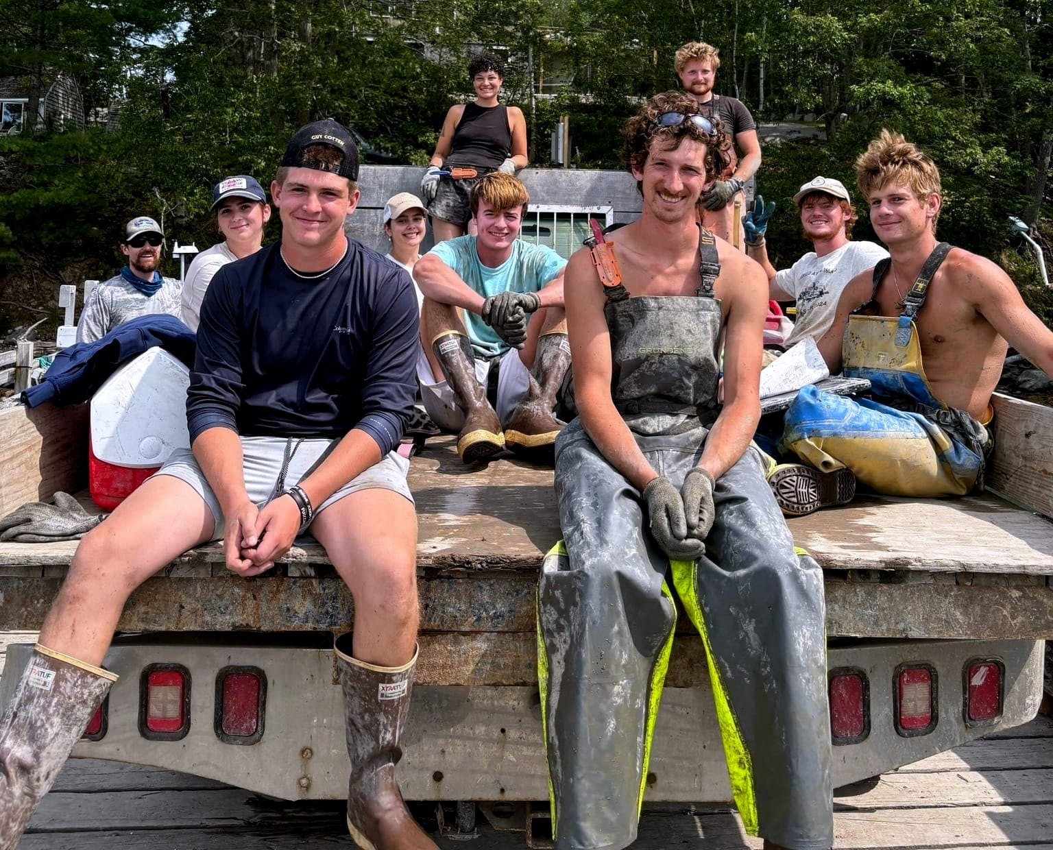 Young oyster farmers on the back of a truck