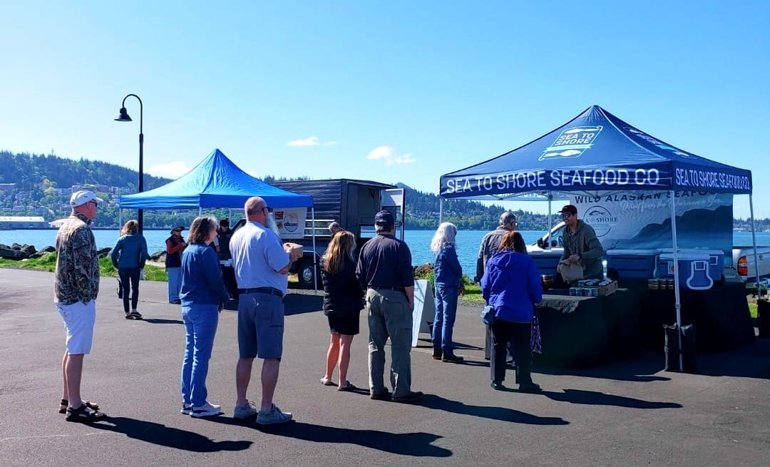 People picking up orders from a seafood stand